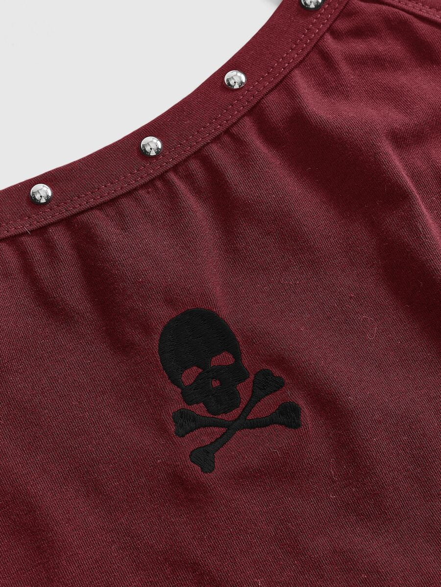 Women's black slim fit cami tank top featuring rhinestone skull accents, shoulder straps, and high-stretch knitted fabric.