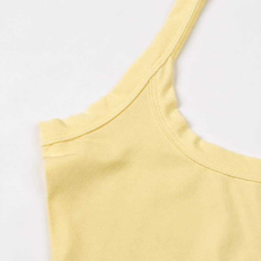A slim fit women's crop cami tank top with spaghetti straps and a solid color design, made from comfortable stretch knitted fabric.