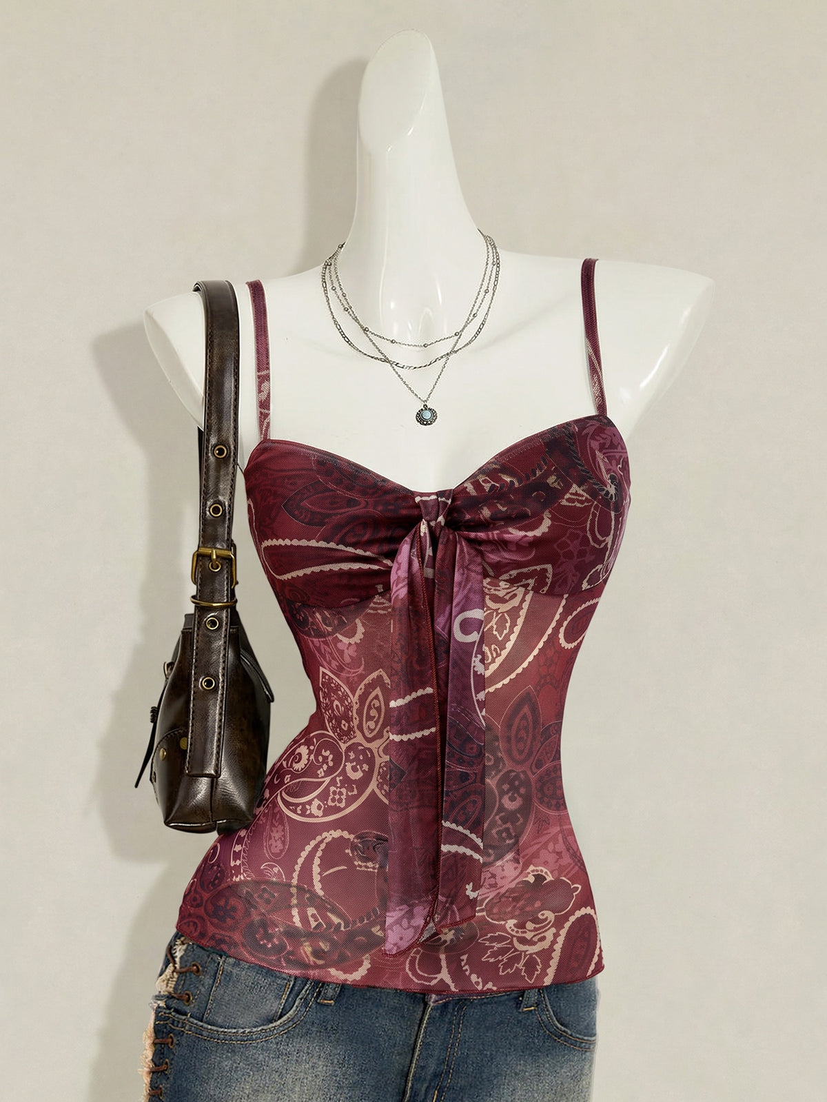 Burgundy paisley print ruched cami top for women featuring thin spaghetti straps, asymmetrical lace-up detail, and a slim fit.
