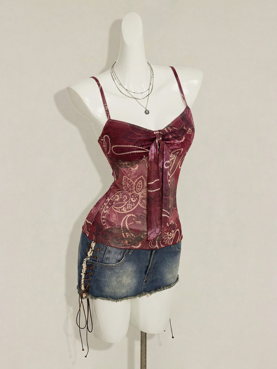 Burgundy paisley print ruched cami top for women featuring thin spaghetti straps, asymmetrical lace-up detail, and a slim fit.