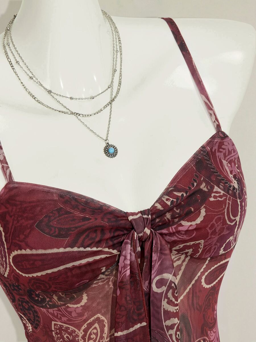 Burgundy paisley print ruched cami top for women featuring thin spaghetti straps, asymmetrical lace-up detail, and a slim fit.
