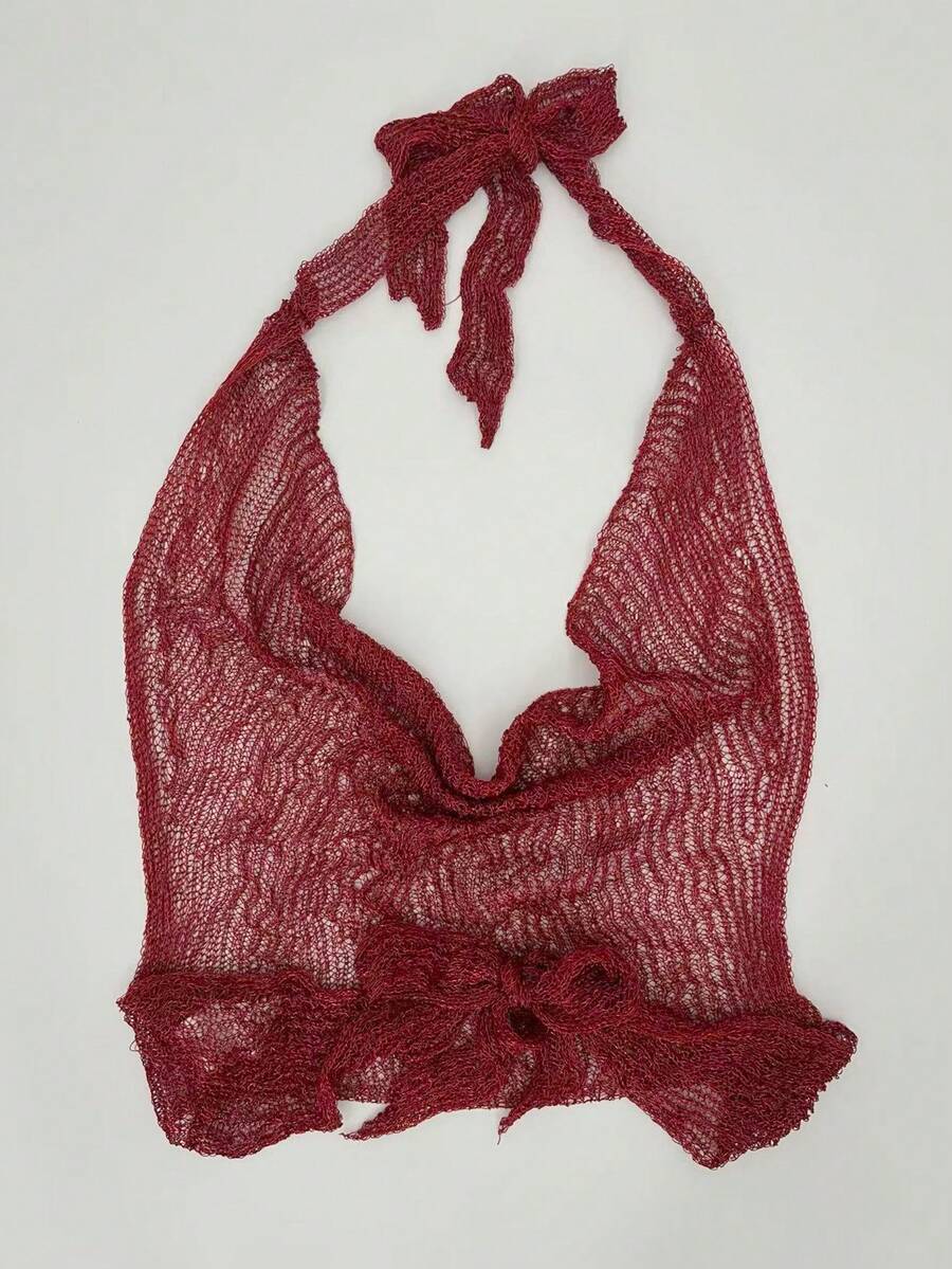 Women's cowl neck metallic knit tank top with thin spaghetti straps and a backless draped silhouette.