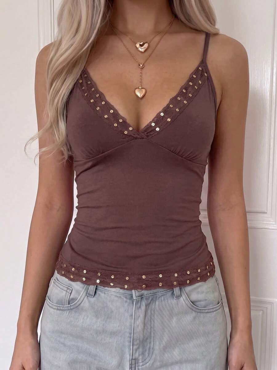 Women's deep V-neck camisole top featuring contrast hollow lace trim, cutout detail, and thin spaghetti straps.