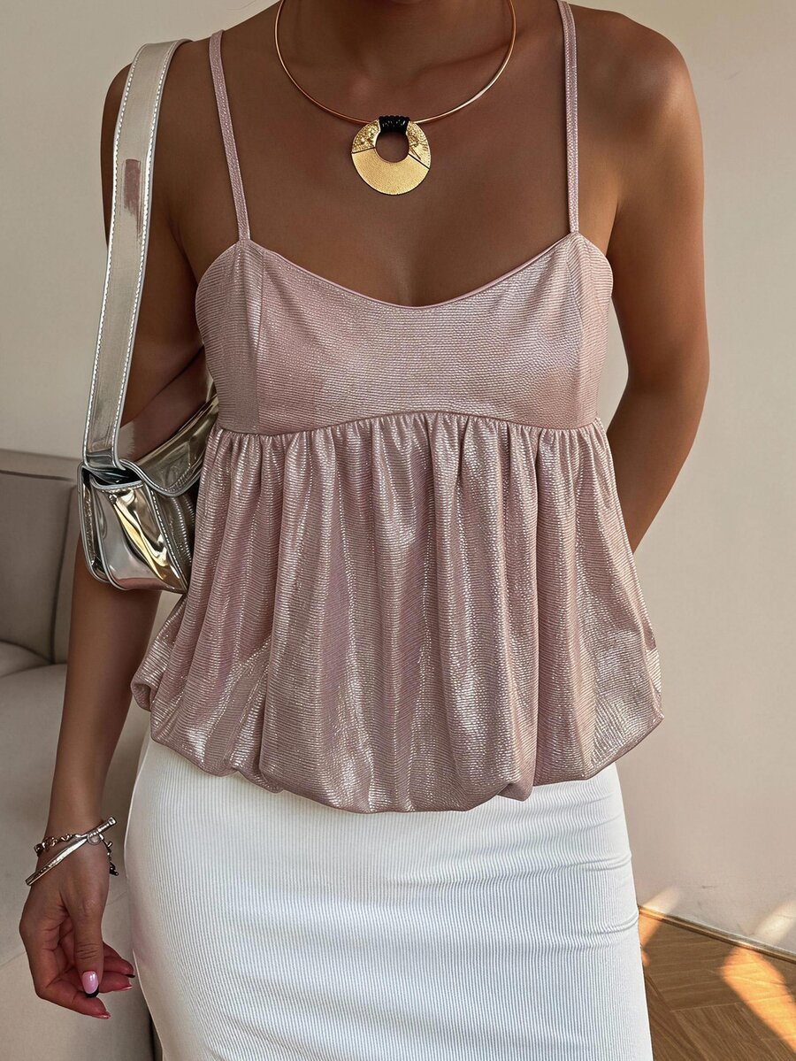 Burgundy sequin spaghetti strap cami top featuring a backless design and flared ruffle hem.