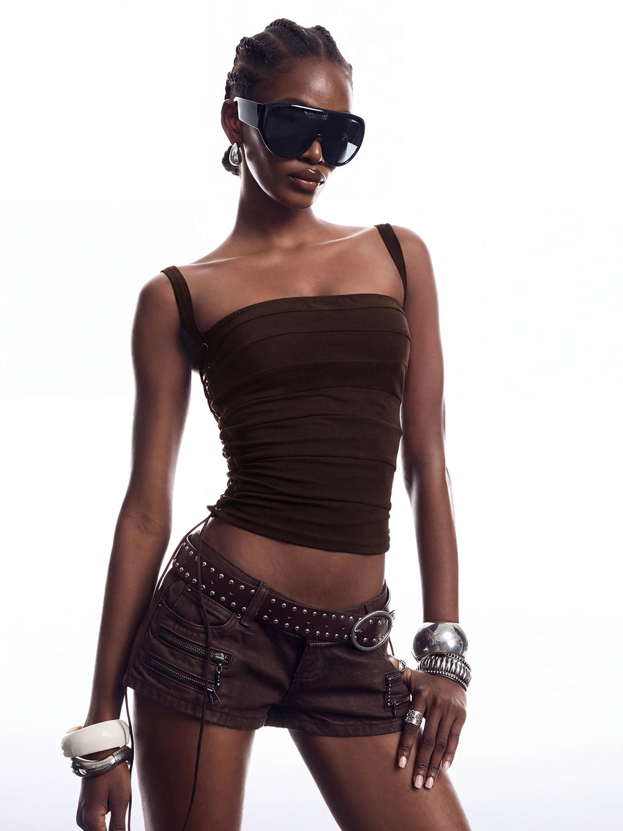 Black PU leather cropped camisole top for women featuring spaghetti straps, side tie details, and a ruched slim fit.