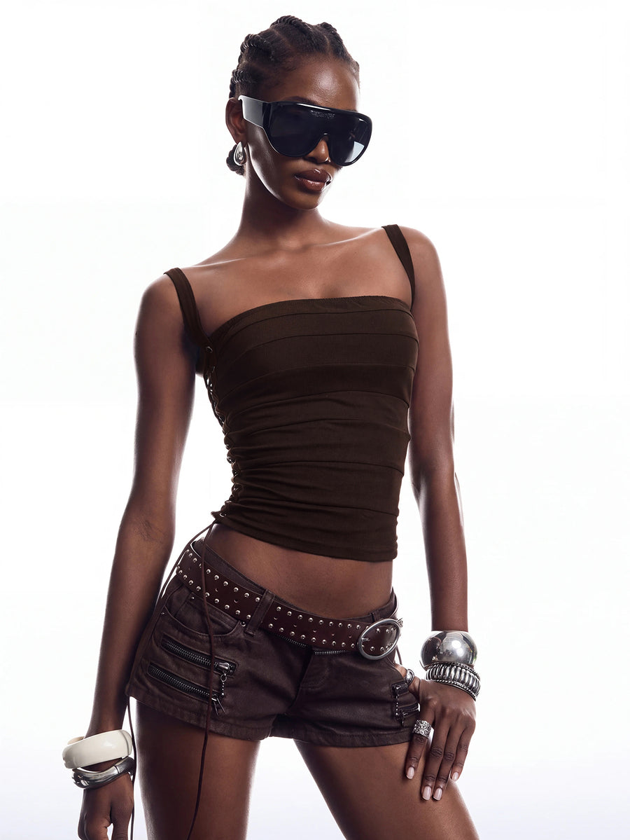 Black PU leather cropped camisole top for women featuring spaghetti straps, side tie details, and a ruched slim fit.