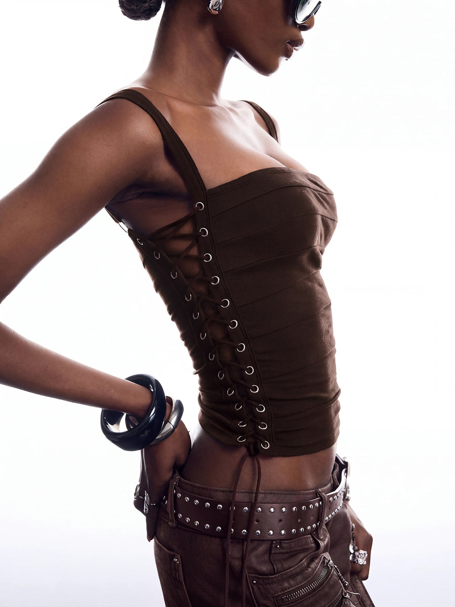 Black PU leather cropped camisole top for women featuring spaghetti straps, side tie details, and a ruched slim fit.