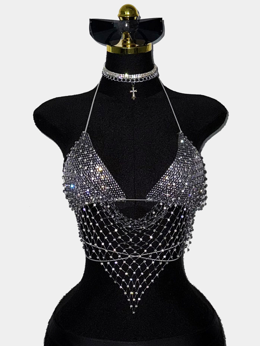 Black sheer mesh halter top for women featuring rhinestone glitter effect, backless design, chain details, and an asymmetrical hem.