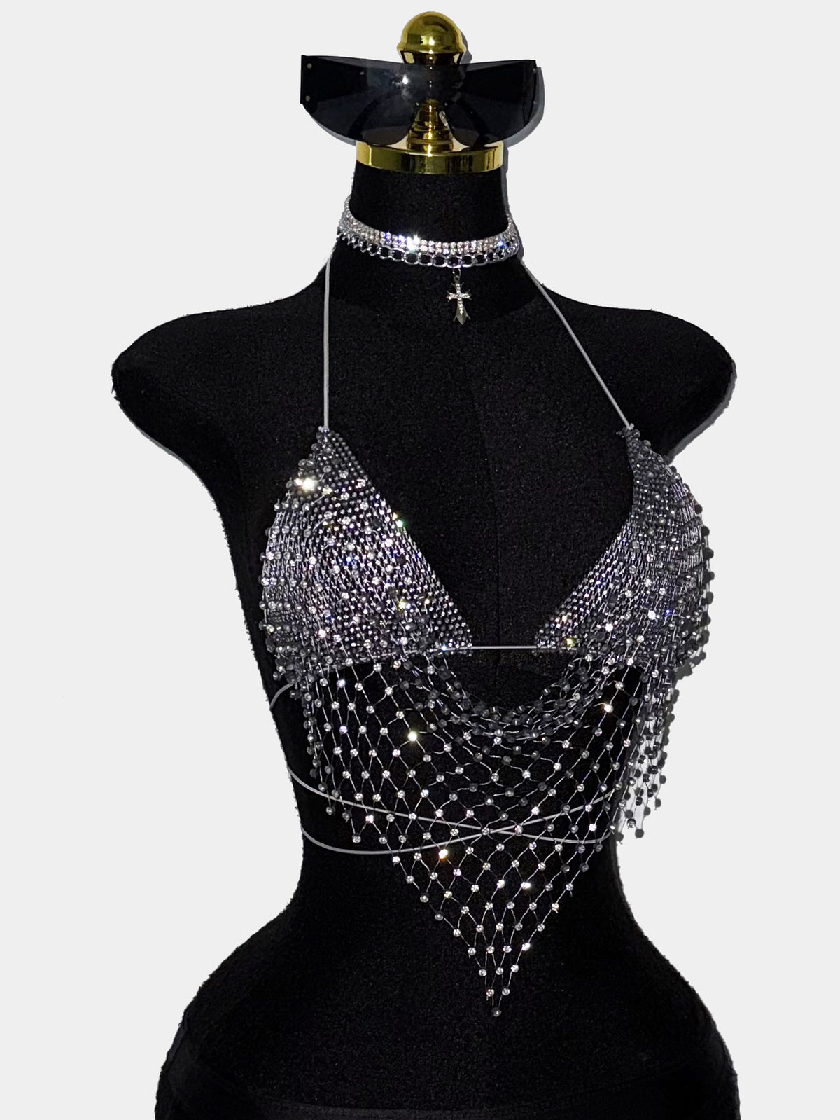 Black sheer mesh halter top for women featuring rhinestone glitter effect, backless design, chain details, and an asymmetrical hem.