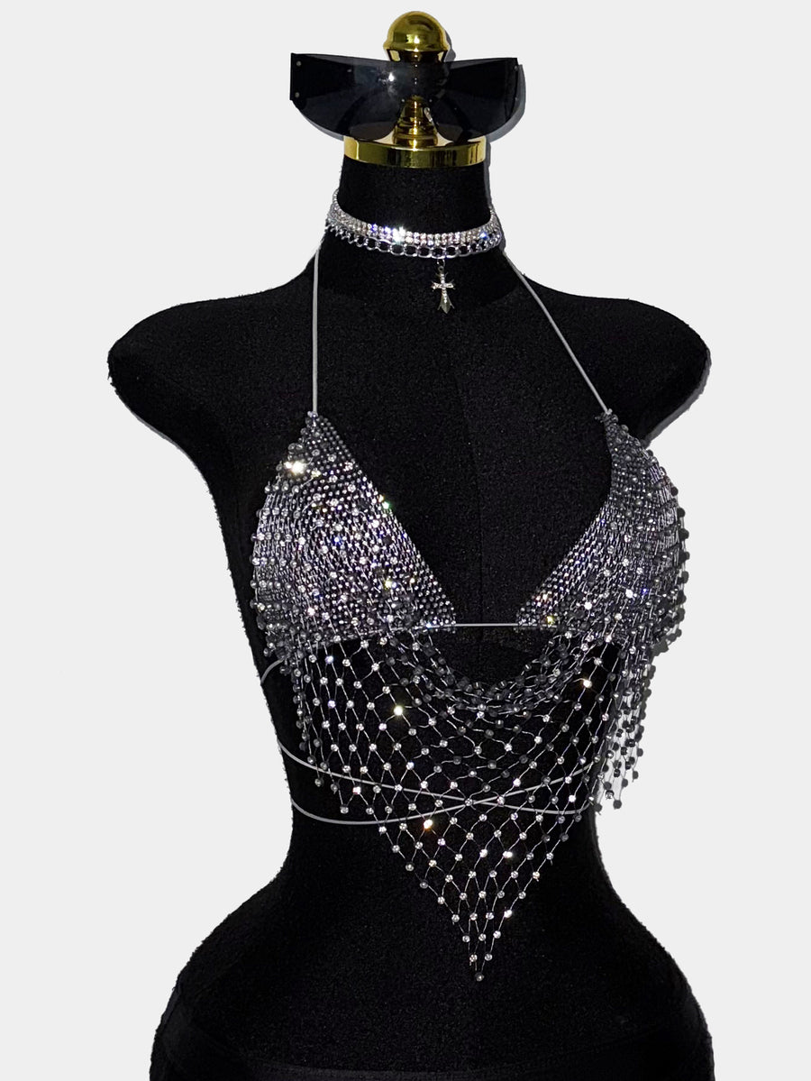 Black sheer mesh halter top for women featuring rhinestone glitter effect, backless design, chain details, and an asymmetrical hem.