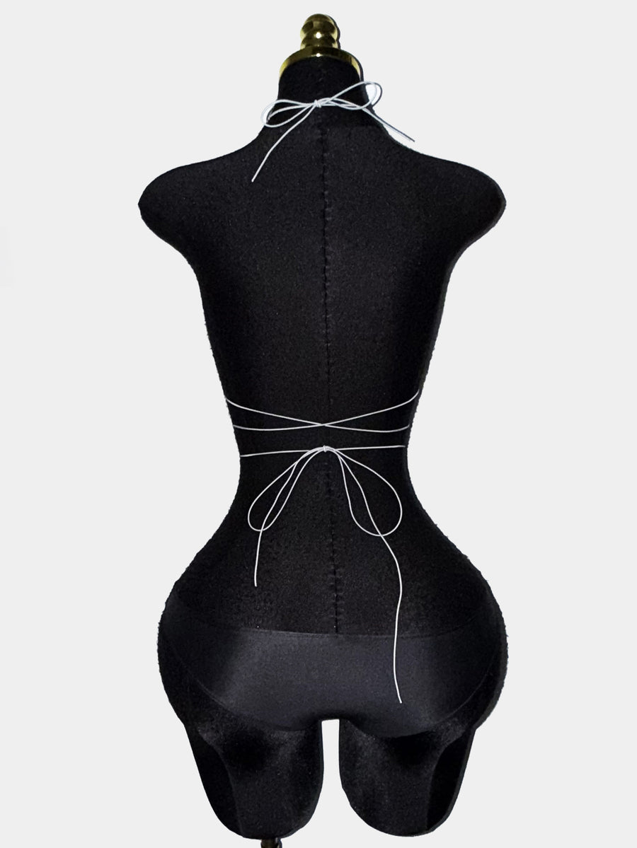 Black sheer mesh halter top for women featuring rhinestone glitter effect, backless design, chain details, and an asymmetrical hem.