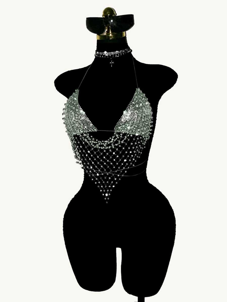 Black sheer mesh halter top for women featuring rhinestone glitter effect, backless design, chain details, and an asymmetrical hem.