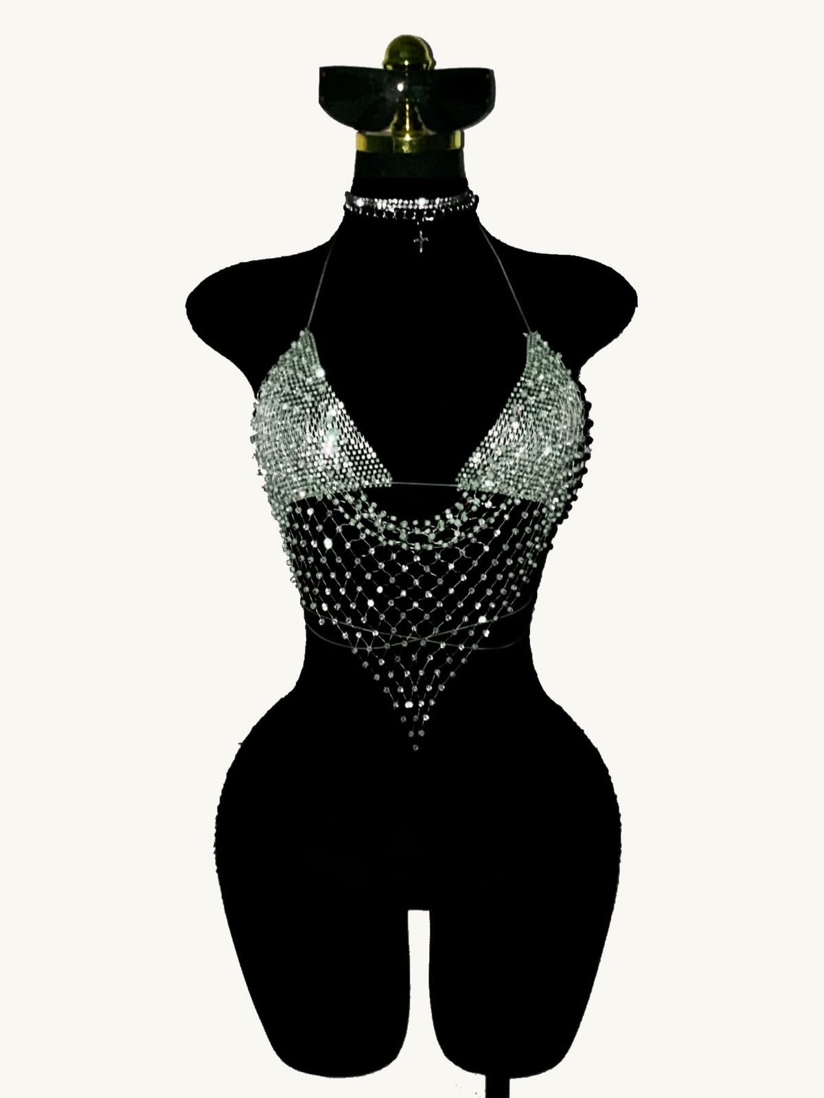 Black sheer mesh halter top for women featuring rhinestone glitter effect, backless design, chain details, and an asymmetrical hem.
