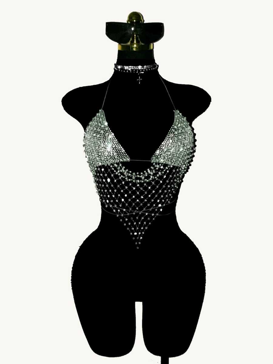 Black sheer mesh halter top for women featuring rhinestone glitter effect, backless design, chain details, and an asymmetrical hem.