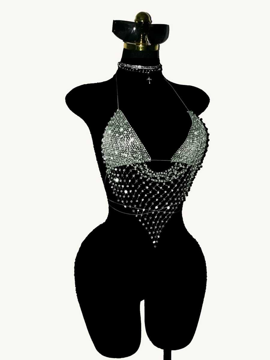Black sheer mesh halter top for women featuring rhinestone glitter effect, backless design, chain details, and an asymmetrical hem.