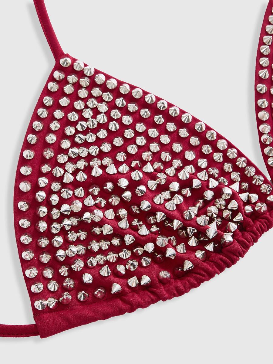 Black studded halter bikini top featuring a backless lace-up design, rhinestone accents, and high-stretch knitted fabric.