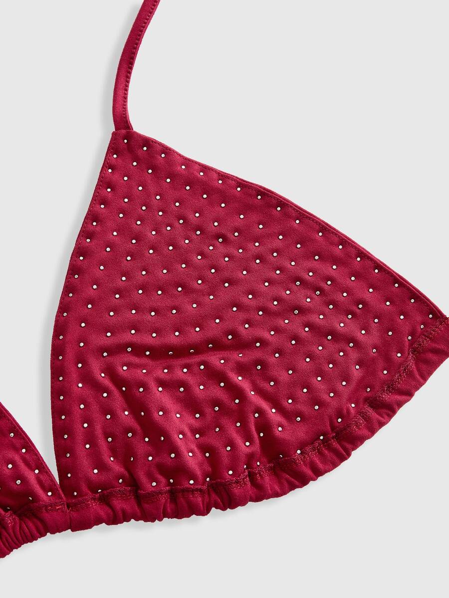 Black studded halter bikini top featuring a backless lace-up design, rhinestone accents, and high-stretch knitted fabric.