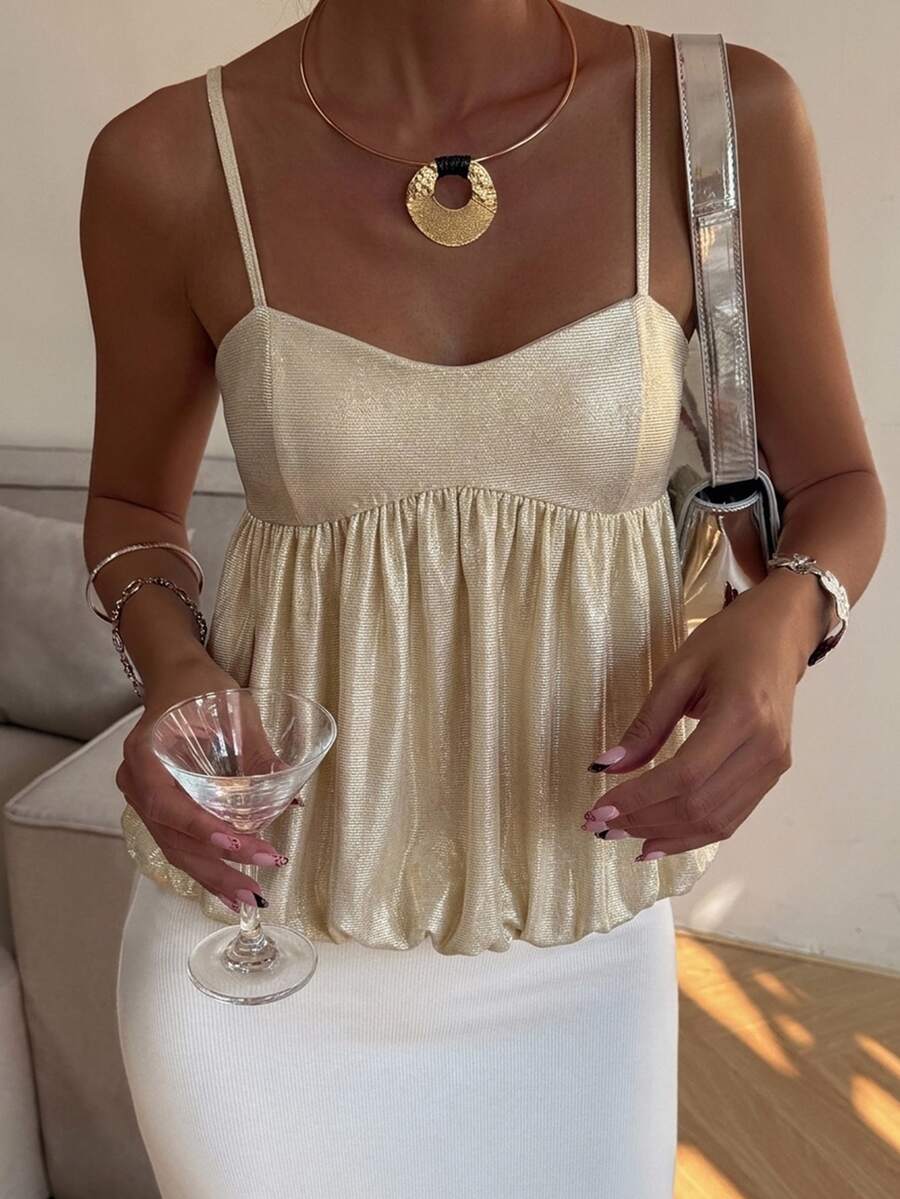 Burgundy sequin spaghetti strap cami top featuring a backless design and flared ruffle hem.