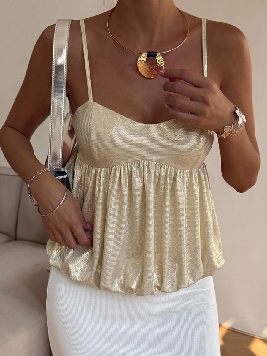 Burgundy sequin spaghetti strap cami top featuring a backless design and flared ruffle hem.