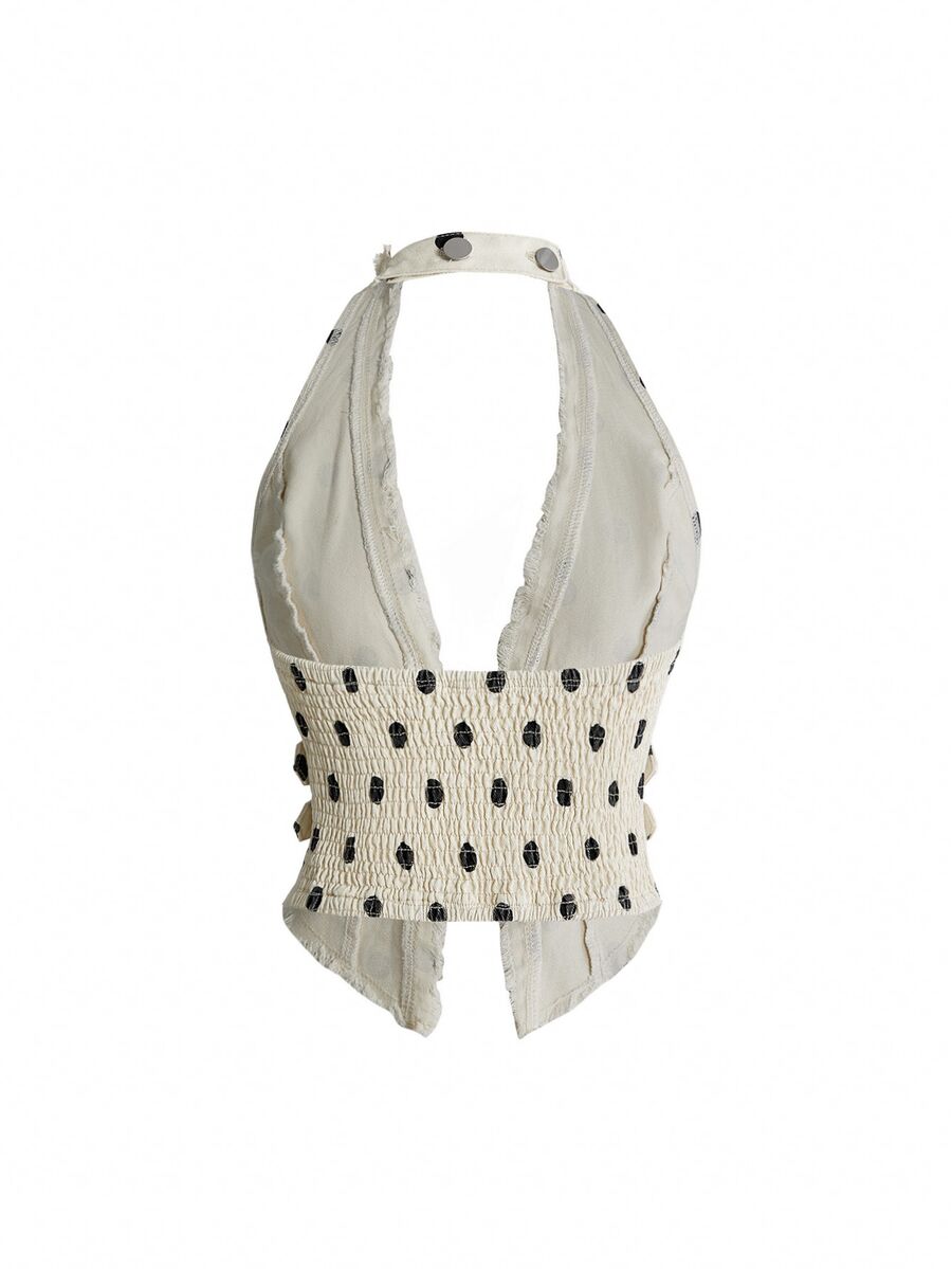 Women's denim halter crop top featuring a backless design, asymmetrical hem, single-breasted front, and lettuce trim.