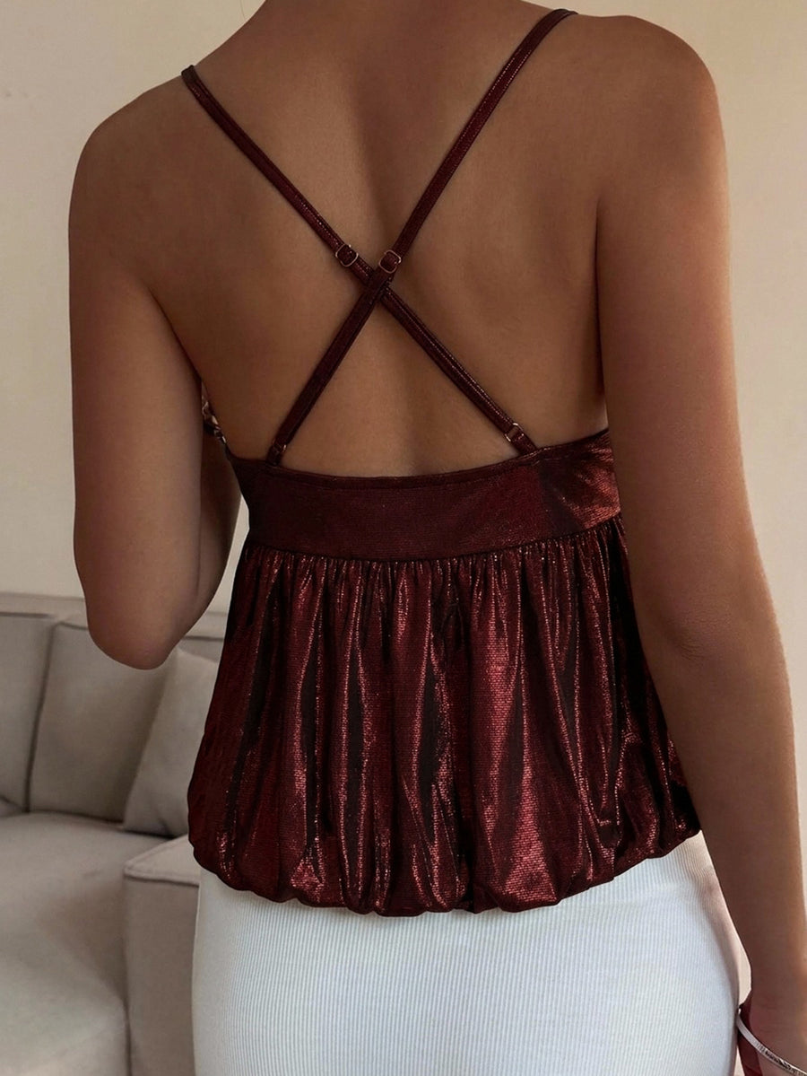 Burgundy sequin spaghetti strap cami top featuring a backless design and flared ruffle hem.