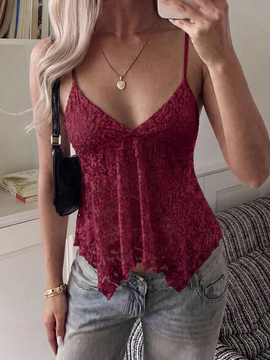 Women's white deep V-neck lace cami top featuring thin straps, semi-sheer lace fabric, and an asymmetrical hemline.
