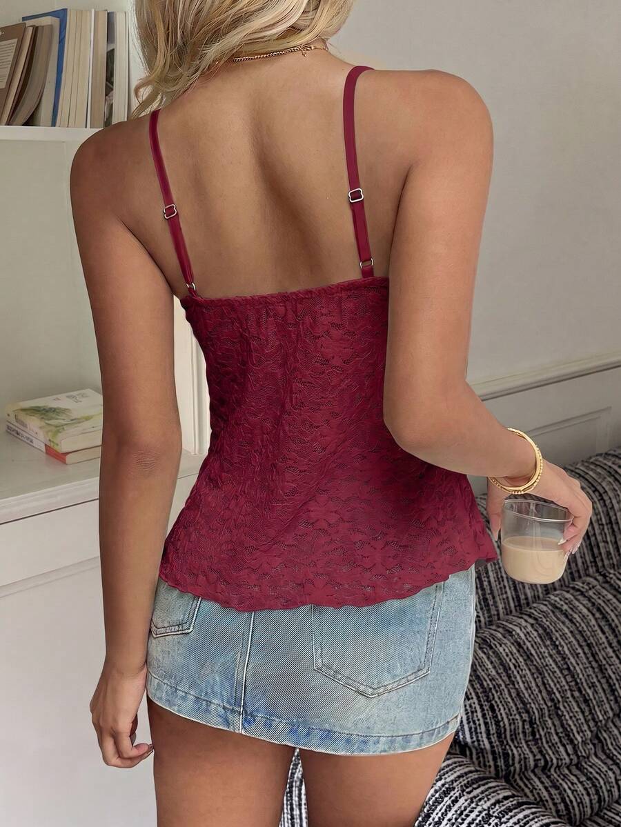 Women's white deep V-neck lace cami top featuring thin straps, semi-sheer lace fabric, and an asymmetrical hemline.