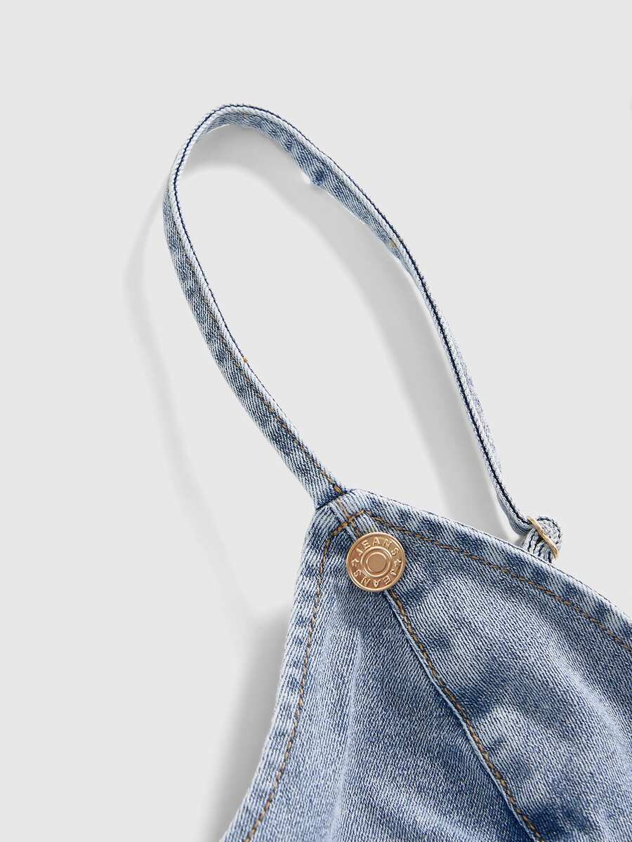 Women's blue fitted denim camisole top featuring metal buckle details, ruched cup design, zipper placket, and thin spaghetti straps.