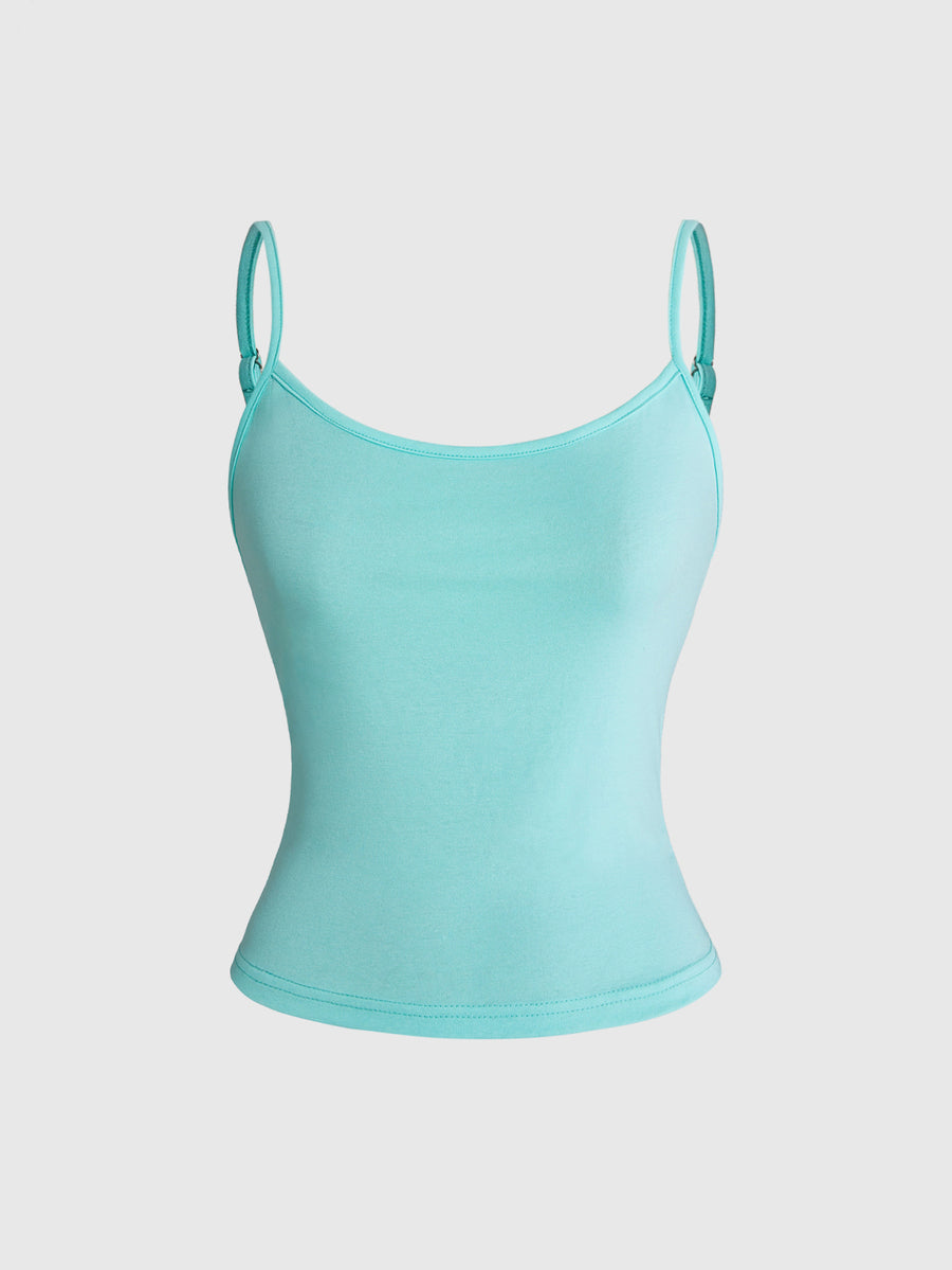 Woman wearing a black backless halter tank top with criss-cross details and textured knit fabric