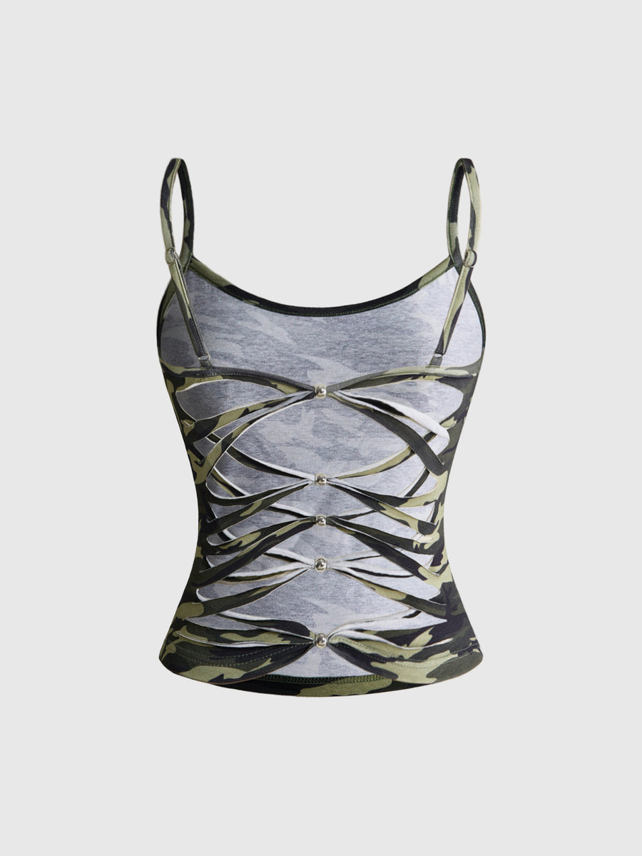 Woman wearing a black backless halter tank top with criss-cross details and textured knit fabric