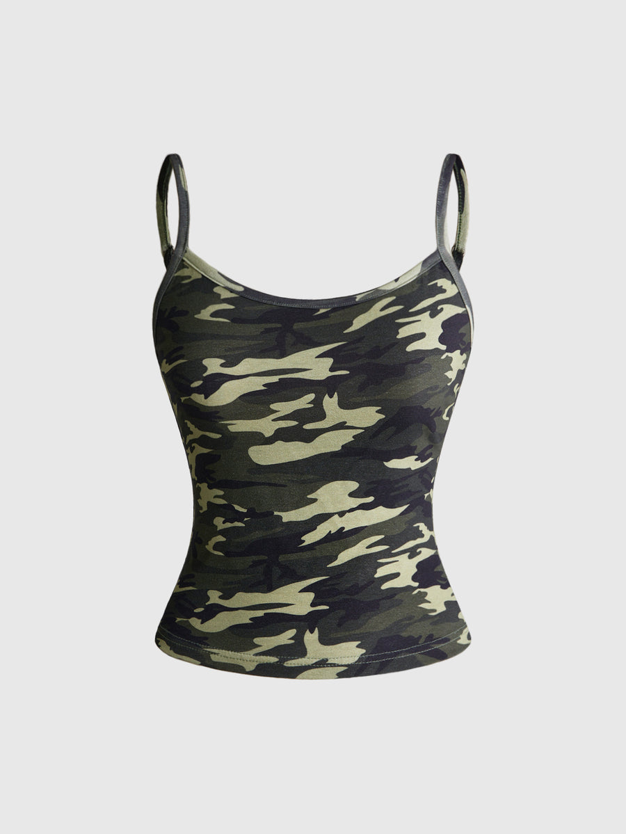 Woman wearing a black backless halter tank top with criss-cross details and textured knit fabric