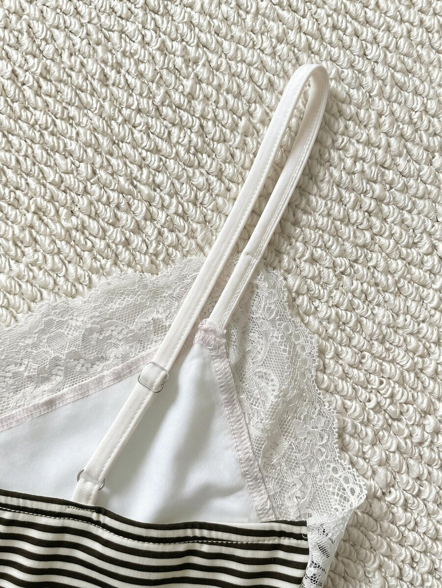 Women's solid color slim fit camisole top featuring delicate lace patchwork embroidery and tank straps.
