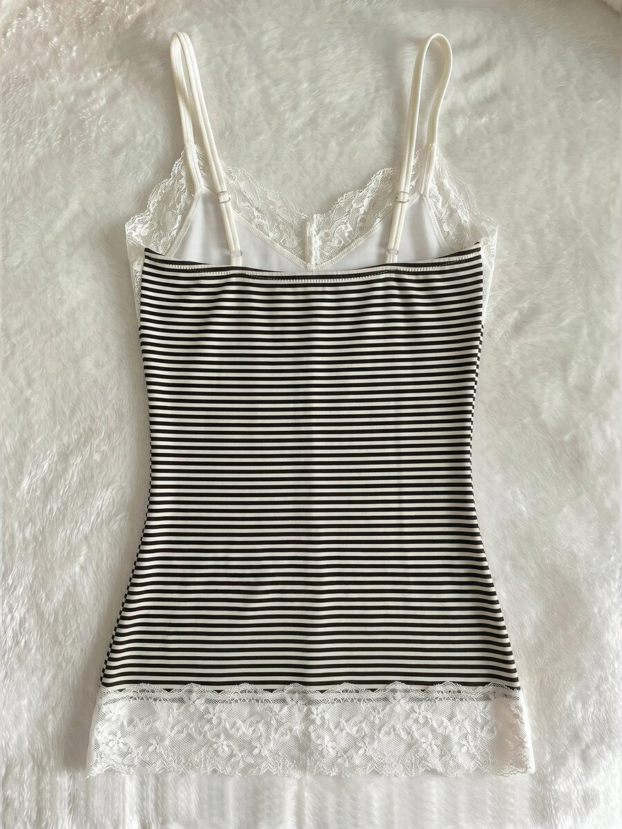 Women's solid color slim fit camisole top featuring delicate lace patchwork embroidery and tank straps.