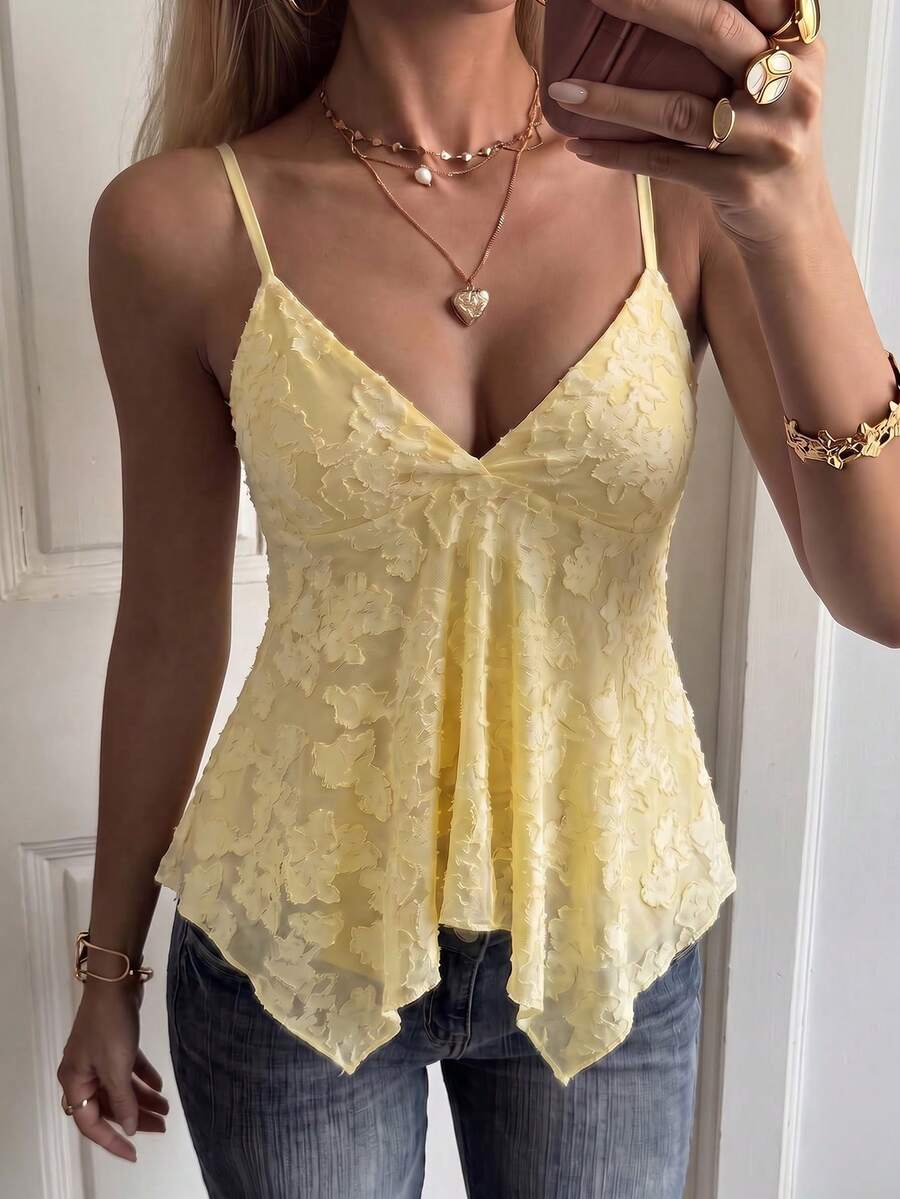 Women's white deep V-neck lace cami top featuring thin straps, semi-sheer lace fabric, and an asymmetrical hemline.