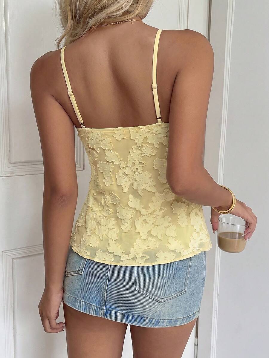 Women's white deep V-neck lace cami top featuring thin straps, semi-sheer lace fabric, and an asymmetrical hemline.