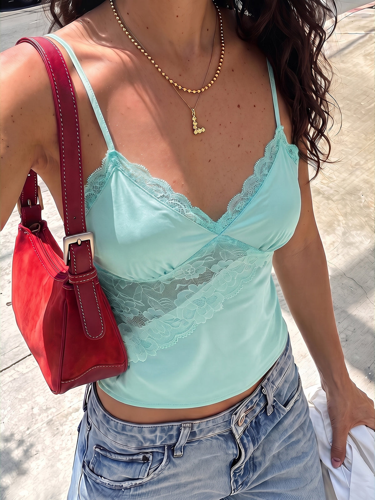 Black woven contrast lace camisole top featuring delicate spaghetti straps and a regular fit.