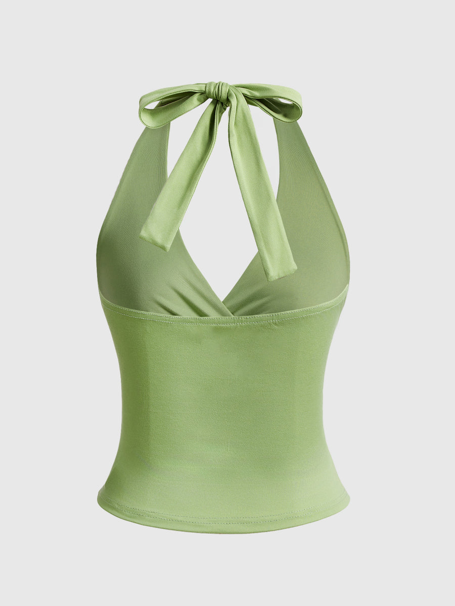 Women's halter crop tank top featuring a backless silhouette and ruched detailing in a slim fit design.