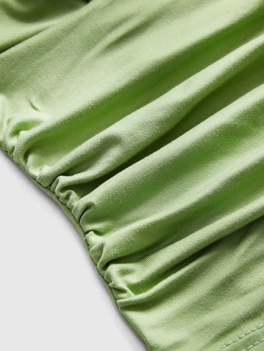Women's halter crop tank top featuring a backless silhouette and ruched detailing in a slim fit design.