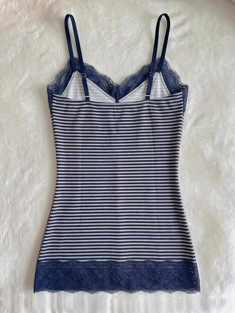 Women's solid color slim fit camisole top featuring delicate lace patchwork embroidery and tank straps.