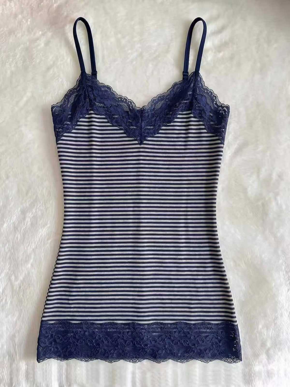 Women's solid color slim fit camisole top featuring delicate lace patchwork embroidery and tank straps.