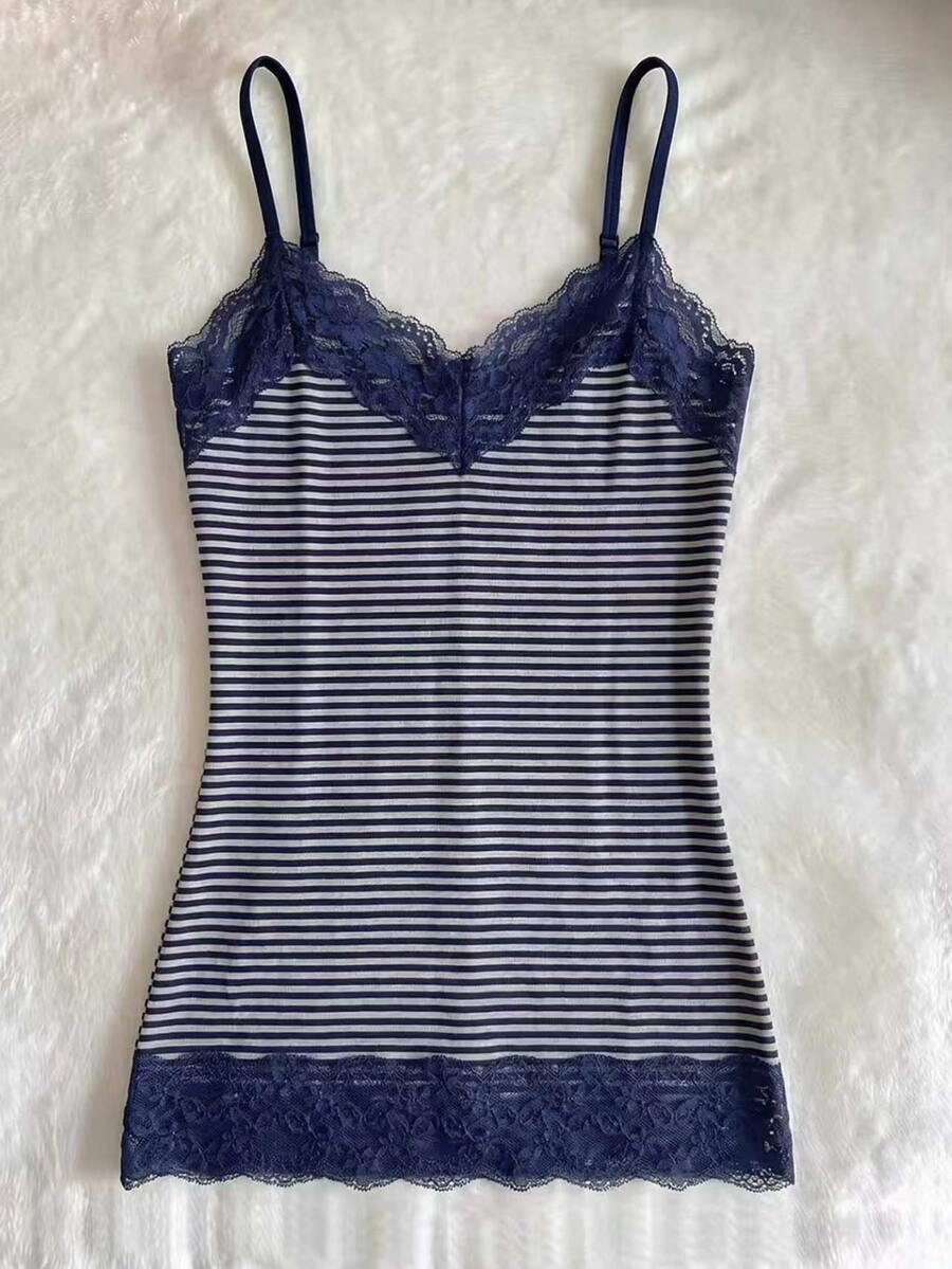 Women's solid color slim fit camisole top featuring delicate lace patchwork embroidery and tank straps.
