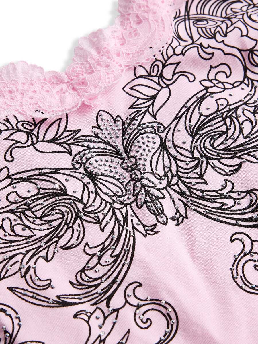 Women's pink crop cami top featuring rhinestone print, contrast lace trim, spaghetti straps, and slim fit cotton-blend fabric.