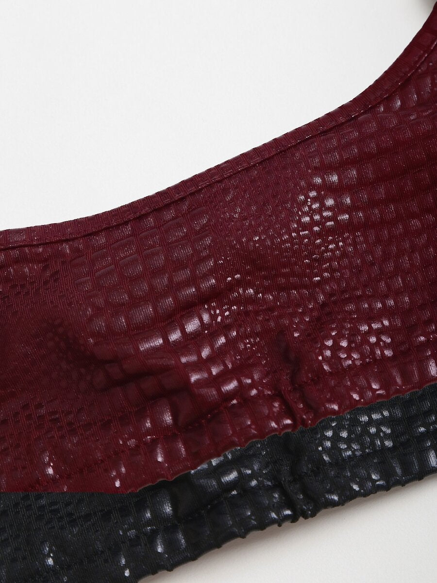 Women's black cropped camisole top with faux crocodile texture, backless spaghetti straps, and matching arm sleeves.