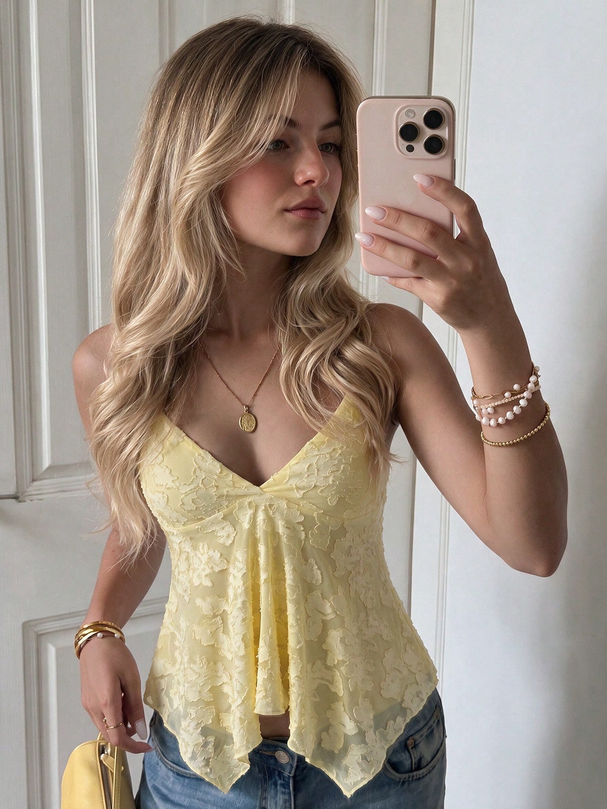 Women's white deep V-neck lace cami top featuring thin straps, semi-sheer lace fabric, and an asymmetrical hemline.