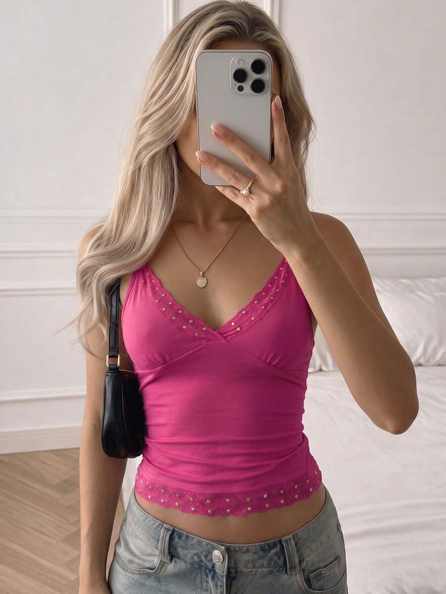 Women's deep V-neck camisole top featuring contrast hollow lace trim, cutout detail, and thin spaghetti straps.