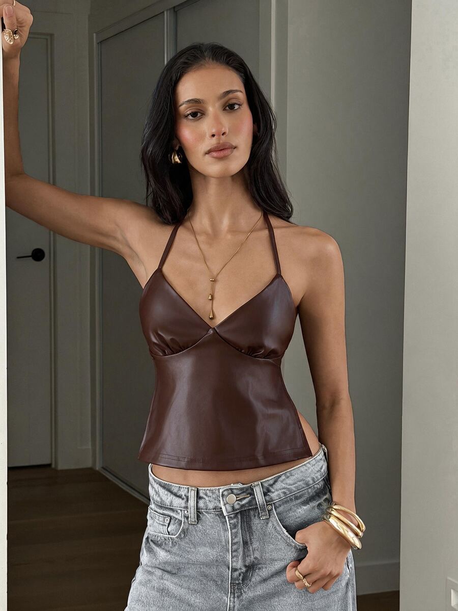 Women's black faux leather backless cami top with spaghetti straps and lace-up shirred sides.