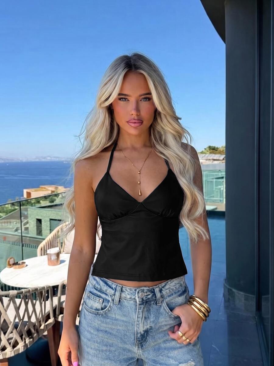 Women's black faux leather backless cami top with spaghetti straps and lace-up shirred sides.