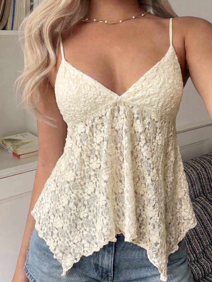 Women's white deep V-neck lace cami top featuring thin straps, semi-sheer lace fabric, and an asymmetrical hemline.