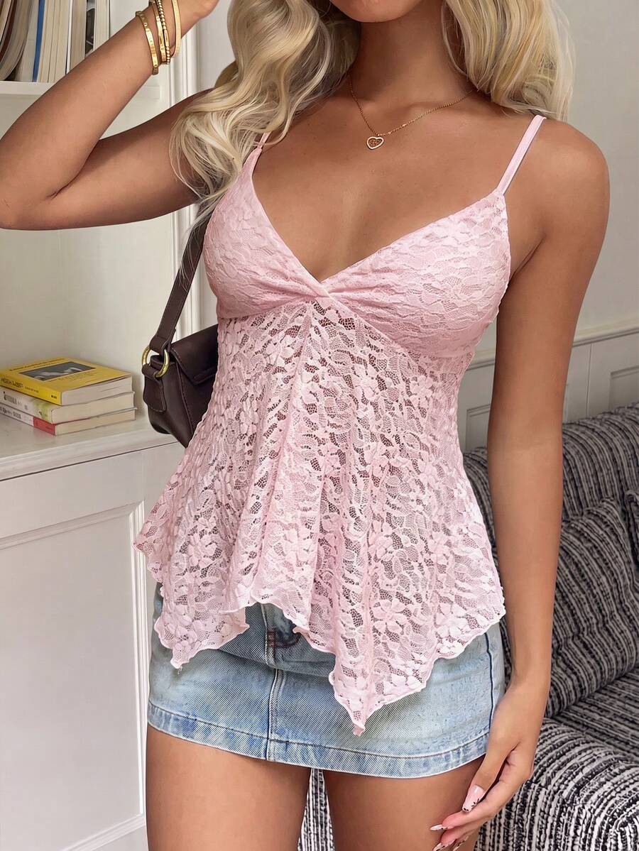 Women's white deep V-neck lace cami top featuring thin straps, semi-sheer lace fabric, and an asymmetrical hemline.