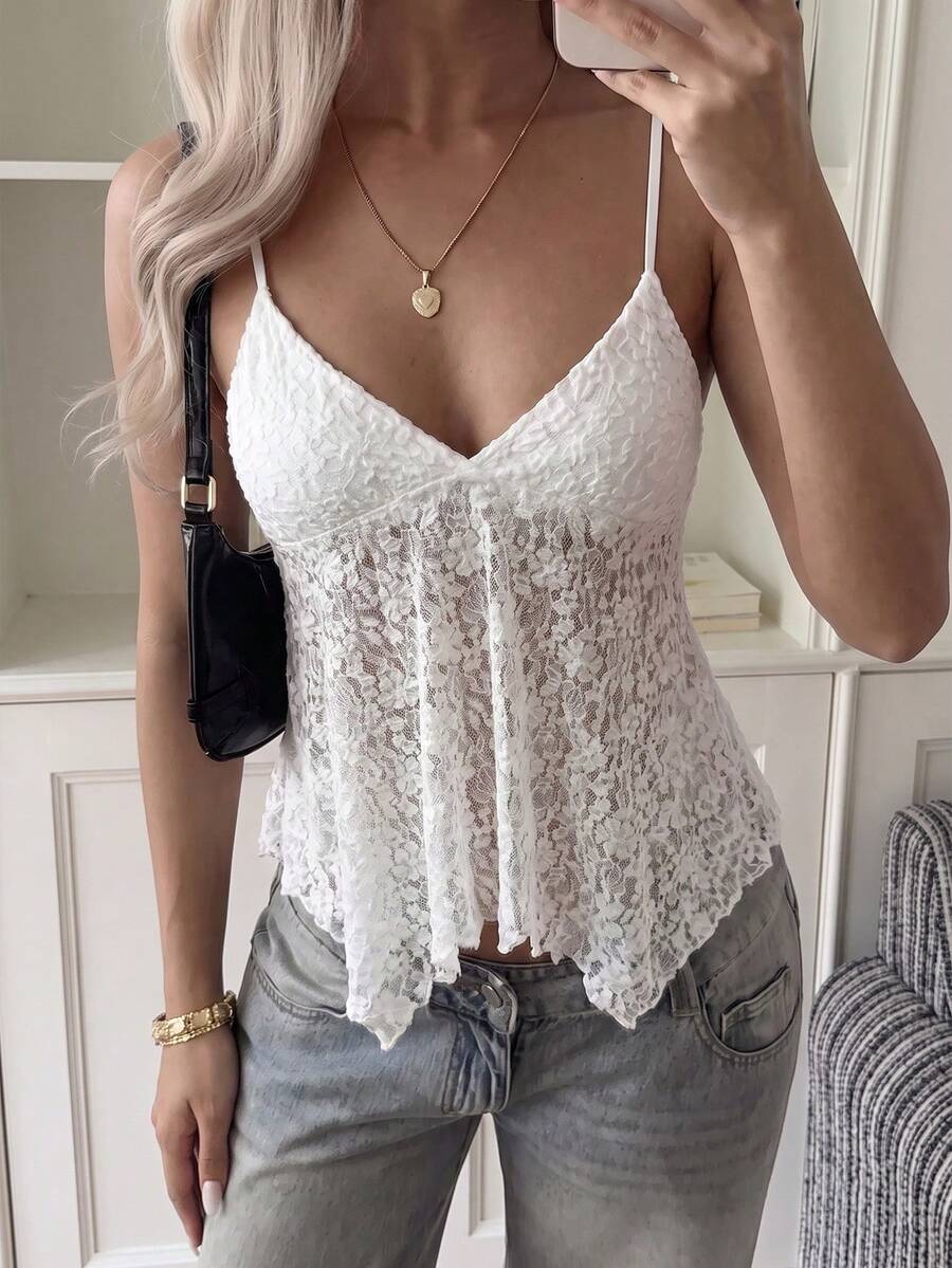 Women's white deep V-neck lace cami top featuring thin straps, semi-sheer lace fabric, and an asymmetrical hemline.